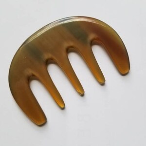 Yak horn glider comb used as scalp massager — five rounded teeth for tension relief and circulation — Arakicrafts
