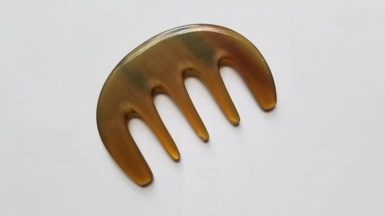 Yak horn glider comb used as scalp massager — five rounded teeth for tension relief and circulation — Arakicrafts