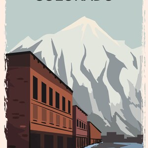 May include: A vintage-style travel poster for Colorado. The image features a row of brick buildings in the foreground, with a snow-capped mountain range in the background. The word "COLORADO" is printed at the top in a bold font.
