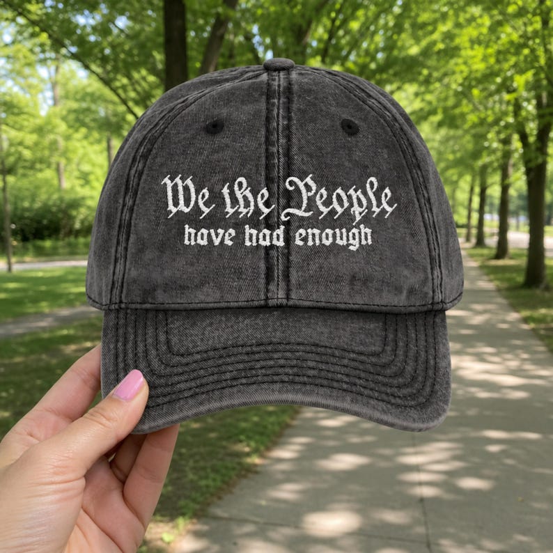 May include: A distressed black baseball cap with the embroidered text "We the People have had enough" in white script. The cap has a curved brim and an adjustable strap.