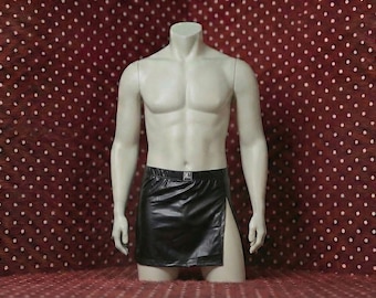 May include: A black faux leather mini skirt with a high side slit and a small silver-toned rectangular logo tag labeled CM centered on the front waistband. The skirt is displayed on a light-colored, headless, armless torso mannequin.