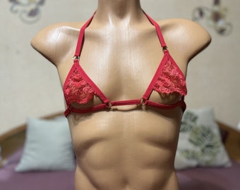 May include: Red lace lingerie top with adjustable straps and a delicate design.