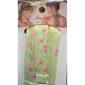 May include: A white ceramic mug with a black handle and the text "But First, Coffee" in a black, handwritten-style font. The mug is on a white surface.