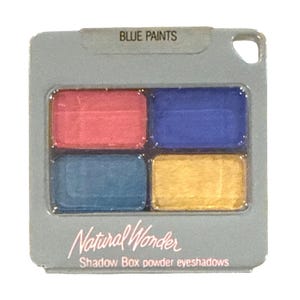 May include: A square eyeshadow palette labeled "BLUE PAINTS" with four rectangular pans of color: red, blue, teal, and yellow. The palette is labeled "Natural Wonder Shadow Box powder eyeshadows".