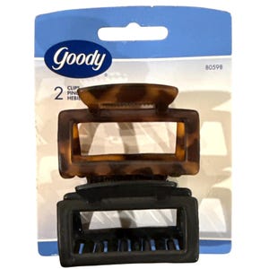 May include: Two Goody hair clips. One is a tortoiseshell pattern, and the other is black. The clips are rectangular with a hinged design. The packaging is blue and white, with the Goody logo and product information.