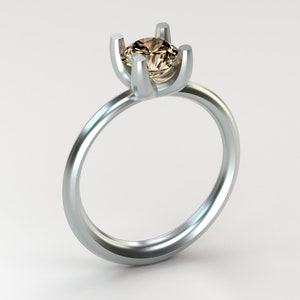 May include: A silver ring with a brown gemstone set in a four-prong setting.
