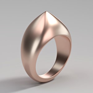 May include: A rose gold ring with a pointed, rounded top. The ring is smooth and shiny.