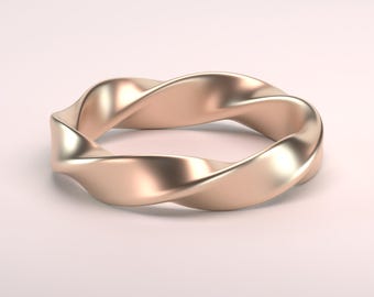 May include: A gold-toned twisted ring with a smooth, polished finish.