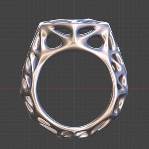 May include: A silver ring with a geometric design. The ring has a textured surface and a hollow center.