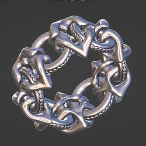 May include: A silver ring with a detailed, intricate design of interlocking hearts and a textured band.