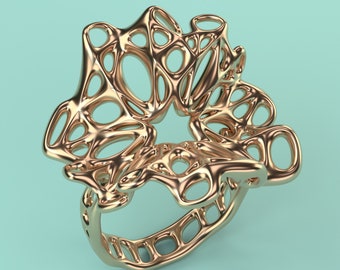 May include: A gold-colored ring with a unique, intricate design. The ring is made of a series of interconnected loops and curves, creating a delicate and airy look.