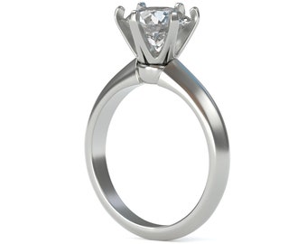 May include: A silver engagement ring with a large, clear diamond set in a four-prong setting.