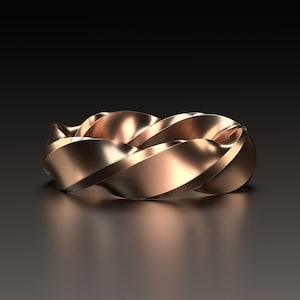 Può includere: Un anello a fascia intrecciata in oro rosa con una finitura liscia e lucida.