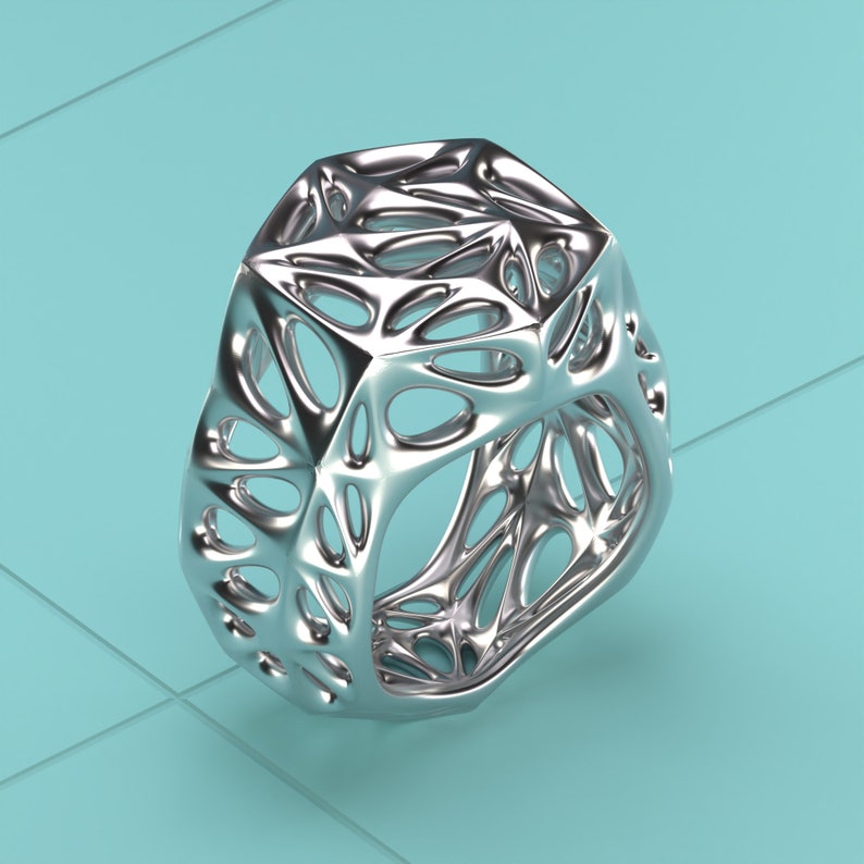 May include: A silver, geometric, openwork ring with a complex, intricate design. The ring is made of a smooth, shiny metal and has a three-dimensional, organic shape.
