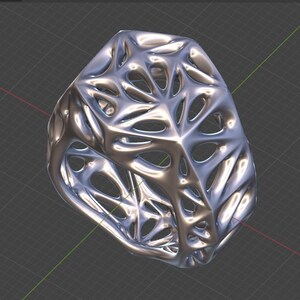 May include: A silver-colored, intricate, openwork ring with a geometric design. The ring is made of a metal with a smooth, polished finish.