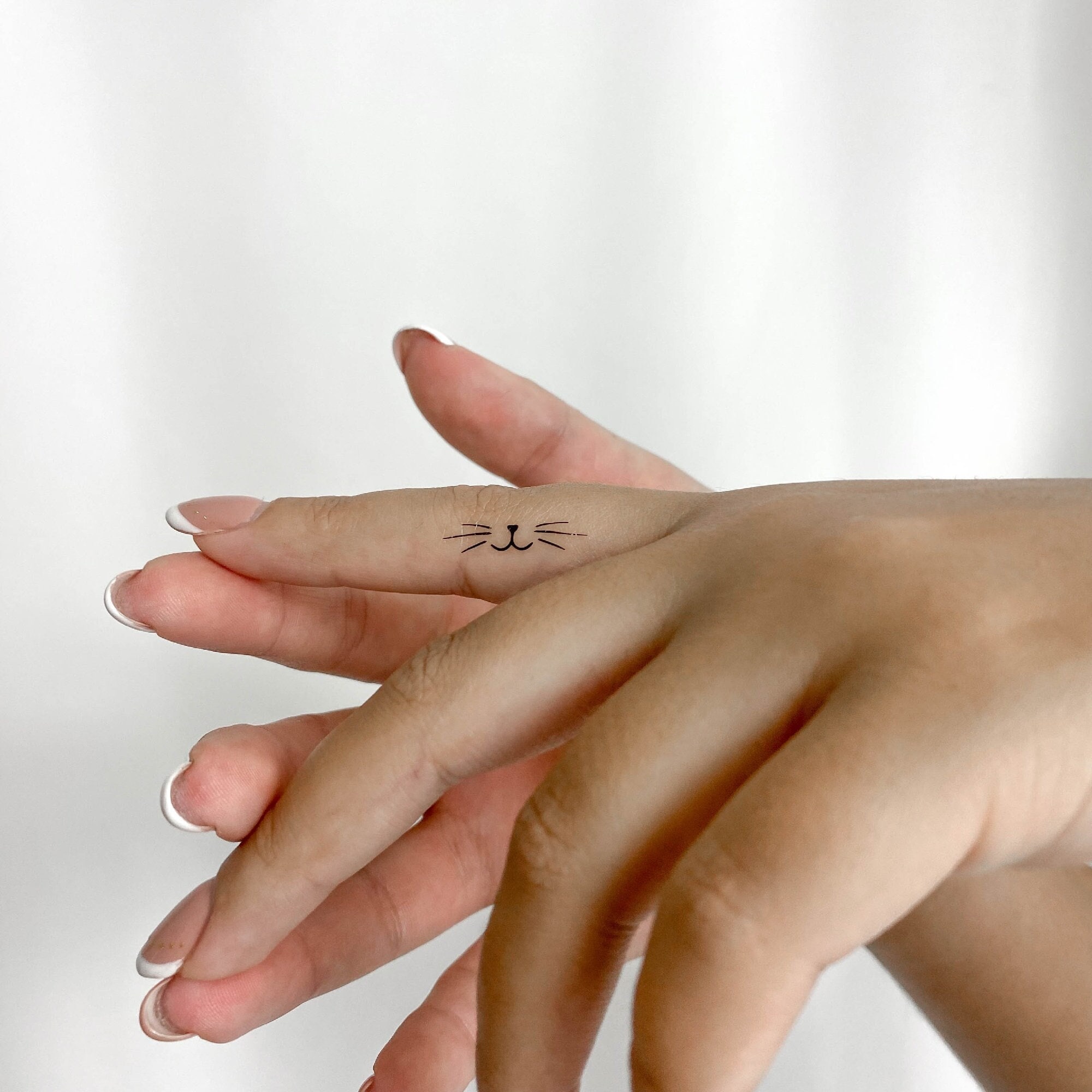Minimalist finger tattoo - triangle, line and circle.