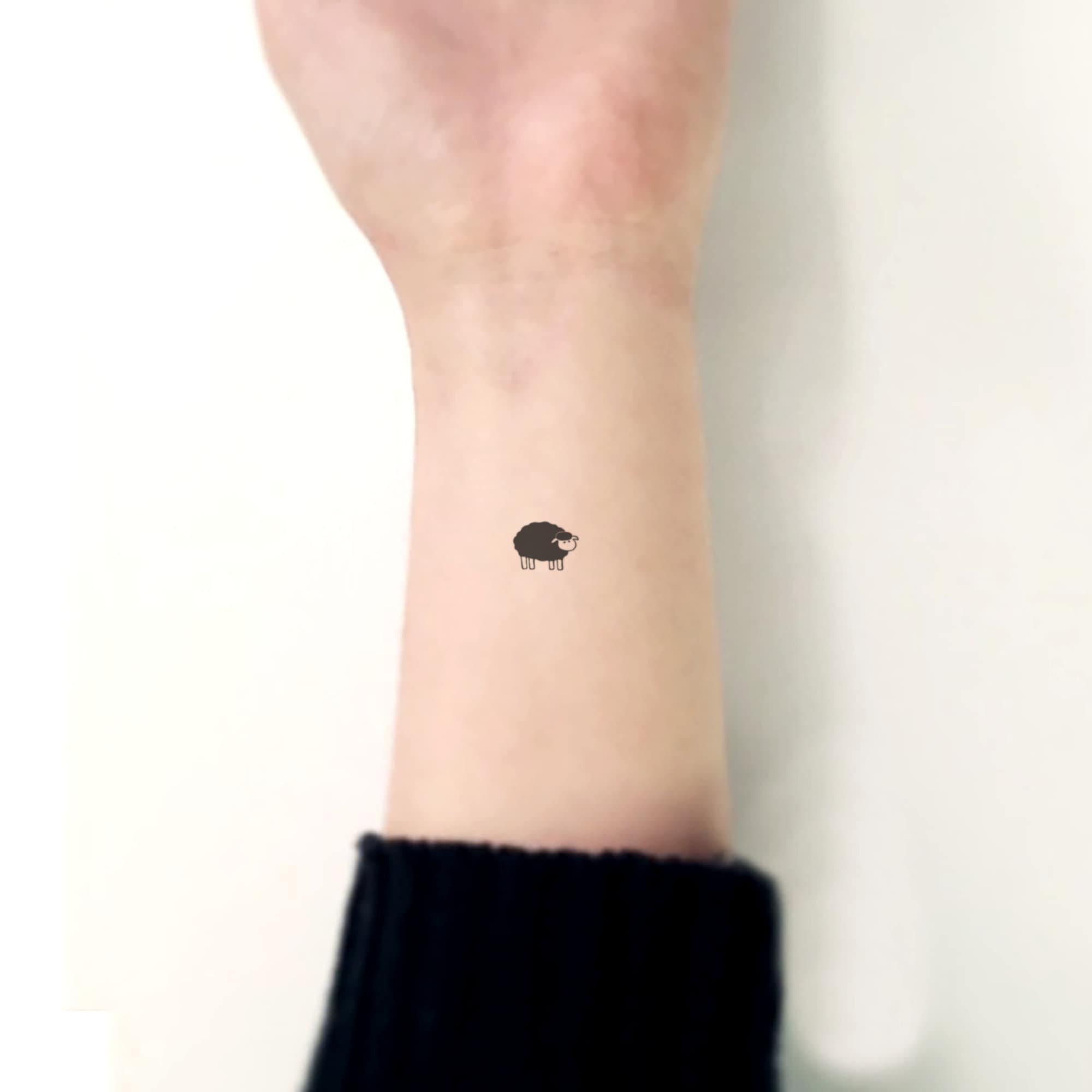 Minimalist sheep tattoo on the wrist