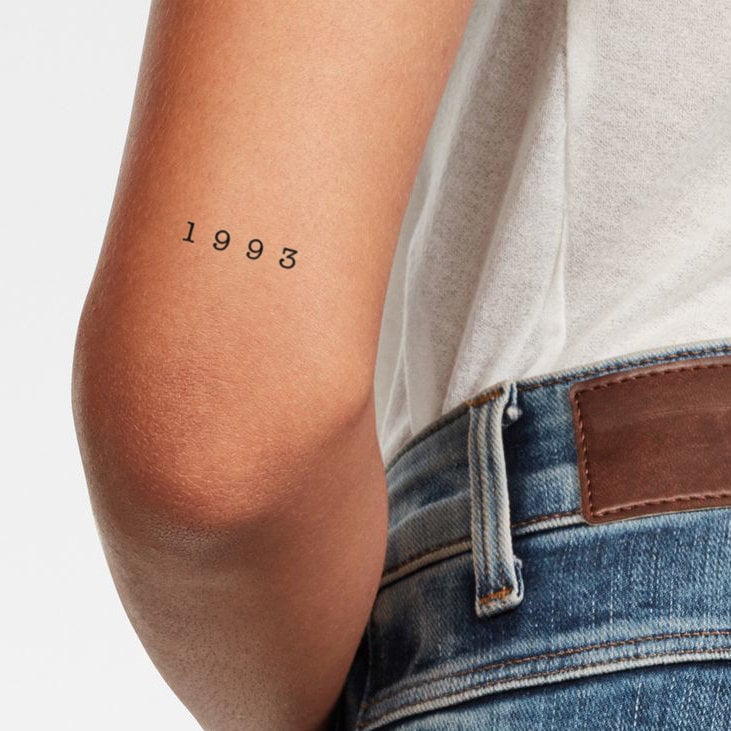 1993 lettering tattoo located on the wrist