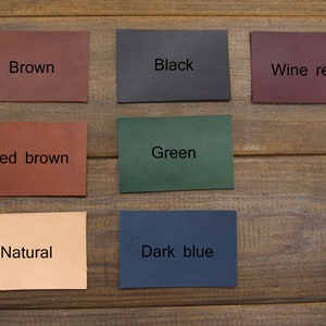 May include: Nine leather swatches in different colors: brown, black, wine red, red brown, green, dark blue, natural.
