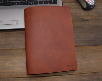 May include: A brown leather notebook cover with the initials "BLW" embossed on the front.