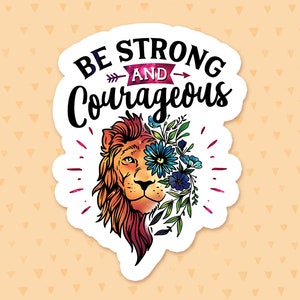 May include: A white sticker featuring a lion's head with colourful flowers and leaves covering its face. The text "Be Strong and Courageous" is above the lion's head.