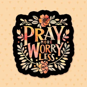 May include: A black and white sticker with a watercolor design of floral accents and the text "Pray More Worry Less".