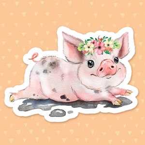 May include: A watercolor illustration of a pink piglet wearing a flower crown. The piglet is lying on its belly with its legs outstretched. The piglet has black spots on its body and is surrounded by a white border.