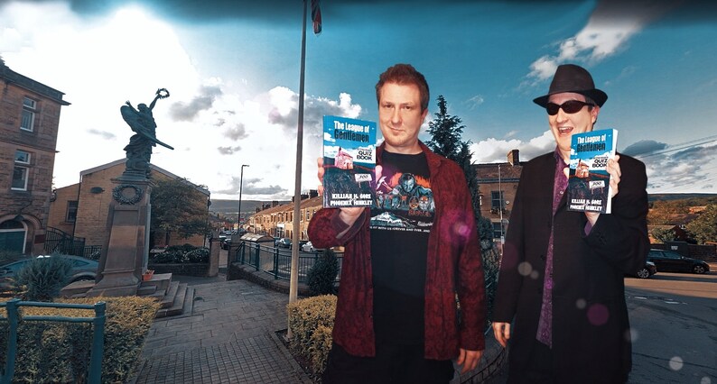 May include: Two people are standing outside holding copies of the book "The League of Gentlemen" by  KILLING IS HARD,  PROVEN BY MURDER. The book cover is blue with a white house and the title in black text.