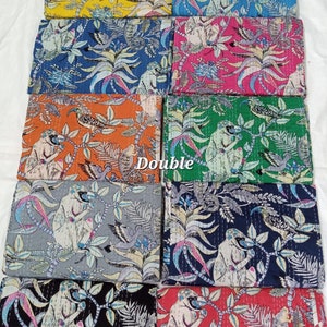 May include: Ten kantha quilts featuring a monkey and bird design. The quilts come in a variety of colours, including yellow, blue, pink, orange, green, grey, black, and red.