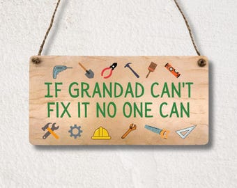 May include: A rectangular wooden hanging sign with a light brown finish and a jute rope. The text reads IF GRANDAD CAN'T FIX IT NO ONE CAN in green letters, surrounded by colorful illustrations of tools including a drill, hammer, and saw.