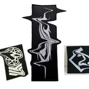 May include: Three black embroidered patches with white designs. The largest patch features a wavy, abstract design. The other two patches feature geometric designs.