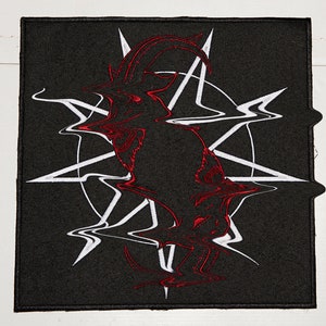 May include: A black embroidered patch with a red goat head inside a white pentagram.