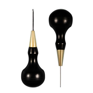 May include: Two leather crafting tools with black wooden handles and gold metal tips. The tools have a pointed tip and a rounded tip.