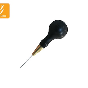 May include: A black leather awl with a brass tip and a black rubber handle.