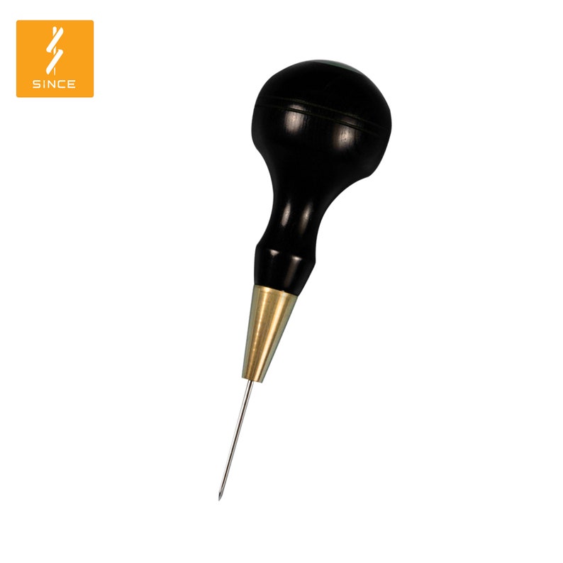 May include: A black wooden awl with a brass tip and a rounded handle. The awl is used for piercing holes in leather or other materials.