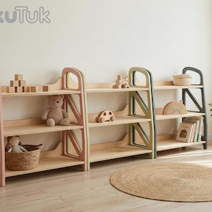 Montessori shelf trio in Dusty Blush, Sage Teal and Slate Gray used as toy storage in a kids play corner, showing wooden toys and books organized on wooden shelves.