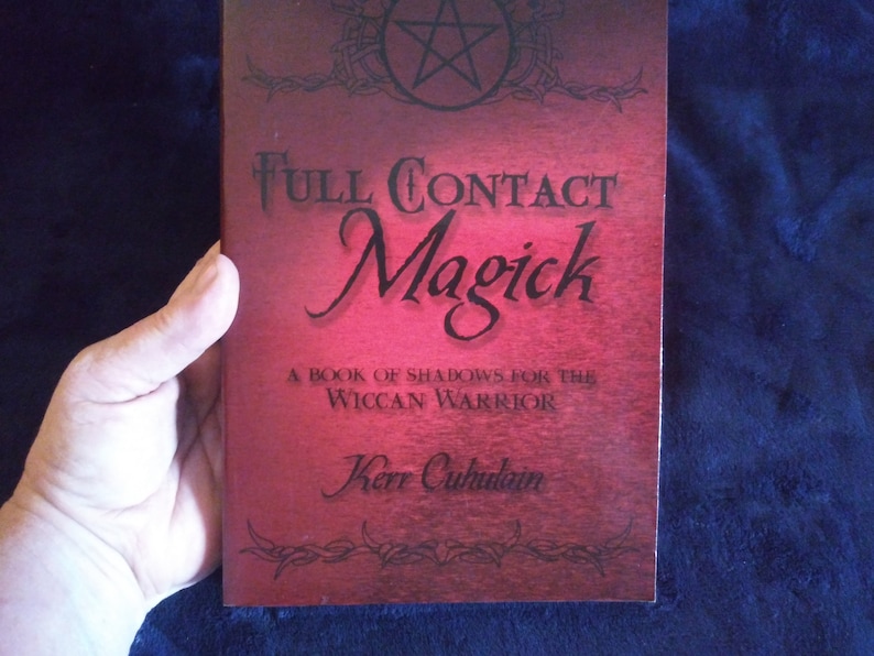 May include: A red book with the title "Full Contact Magick" and the subtitle "A Book of Shadows for the Wiccan Warrior". The author's name is Kerr Cuhulain.