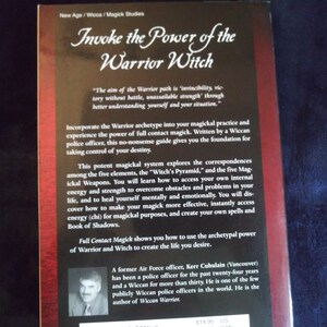 May include: Book cover for "Invoke the Power of the Warrior Witch" by Kerr Cuhulain. The cover features a dark background with gold lettering and a photo of the author. The text on the back cover describes the book as a guide to "full contact magick" and how to access your own internal energy and strength.