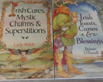 May include: Two vintage books with colorful covers. The left book is titled "Irish Cures, Mystic Charms & Superstitions" by Lady Wilde. The right book is titled "Irish Toasts, Curses & Blessings" by Padraic O'Farrell. Both books feature illustrations.