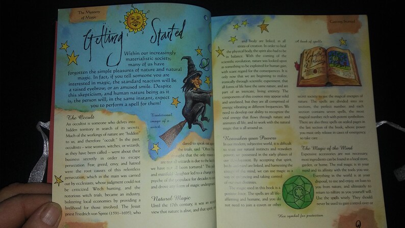 May include: An open book with a green symbol on the cover, titled "The Magic of the Wind." The book is open to a page with text about the magical nature of the wind and how to use it for protection.