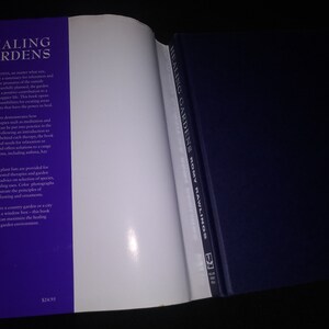May include: A purple and white book titled "Healing Gardens" by Romy Rawlings. The book cover features text about the power of gardens to heal and includes information about the philosophy behind each therapy.