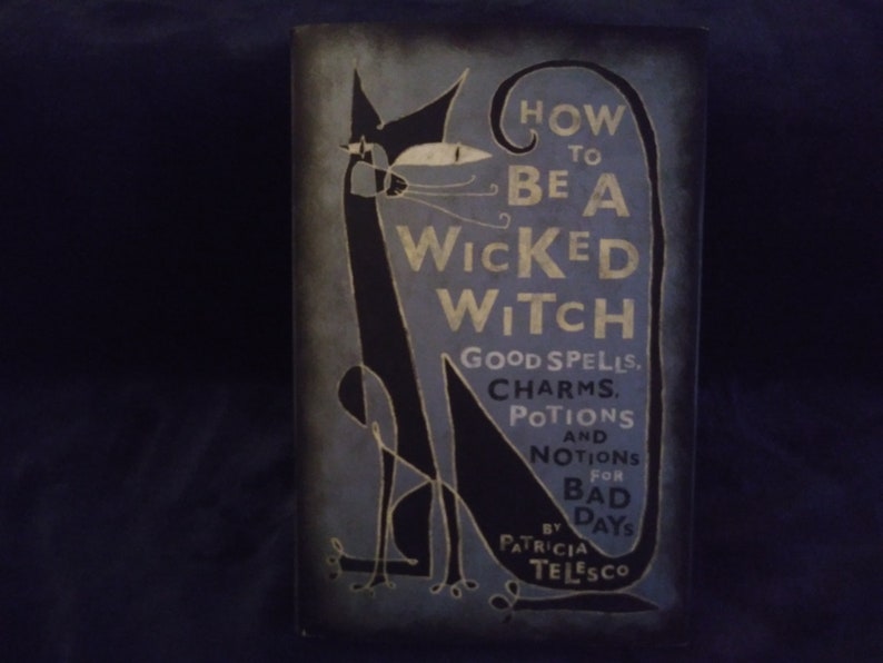 May include: Book cover with a black cat illustration and the title "How to Be a Wicked Witch: Good Spells, Charms, Potions and Notions for Bad Days" by Patricia Telesco.