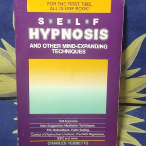 May include: A book titled "Self Hypnosis and Other Mind-Expanding Techniques" with a purple cover. The cover has yellow and green rectangular designs. The text includes "For the first time, all in one book!" and the author's name, Charles Tebbetts.
