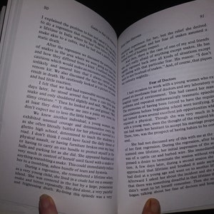 May include: Open book with a close-up of a finger pointing to a section of text that reads "Fear of Doctors". The text discusses a young woman's fear of doctors and hospitals.