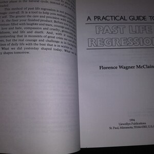 May include: A white book with black text on the cover. The title is "A Practical Guide to Past Life Regression" by Florence Wagner McClain. The book was published in 1994 by Llewellyn Publications in St. Paul, Minnesota.