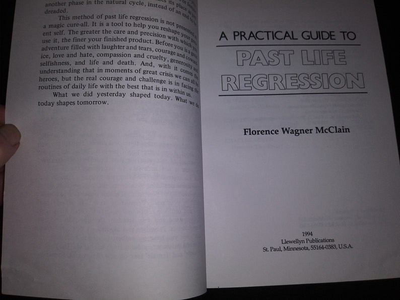 May include: A white book with black text on the cover. The title is "A Practical Guide to Past Life Regression" by Florence Wagner McClain. The book was published in 1994 by Llewellyn Publications in St. Paul, Minnesota.