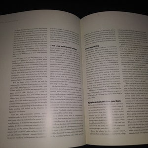 May include: Open book with a white background and black text. The book is about the use of herbs in medicine and gardening. The text discusses the history of herbal medicine, homeopathy, and the use of herbs in the garden.