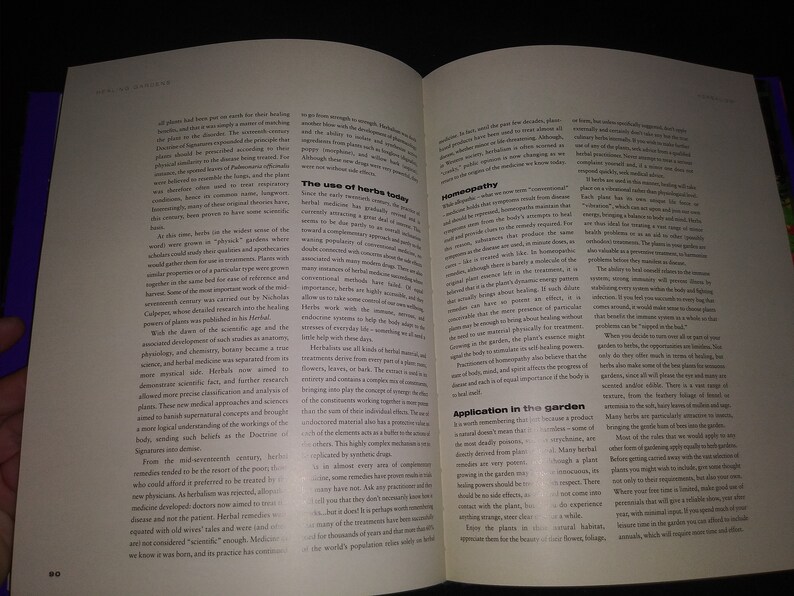 May include: Open book with a white background and black text. The book is about the use of herbs in medicine and gardening. The text discusses the history of herbal medicine, homeopathy, and the use of herbs in the garden.