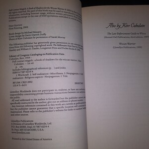 May include: A book titled "Full Contact Magick: A Book of Shadows for the Wiccan Warrior" by Kerr Cuhulain. The book cover is white with black text. The back cover lists other books by the author, including "The Law Enforcement Guide to Wicca" and "Wiccan Warrior".