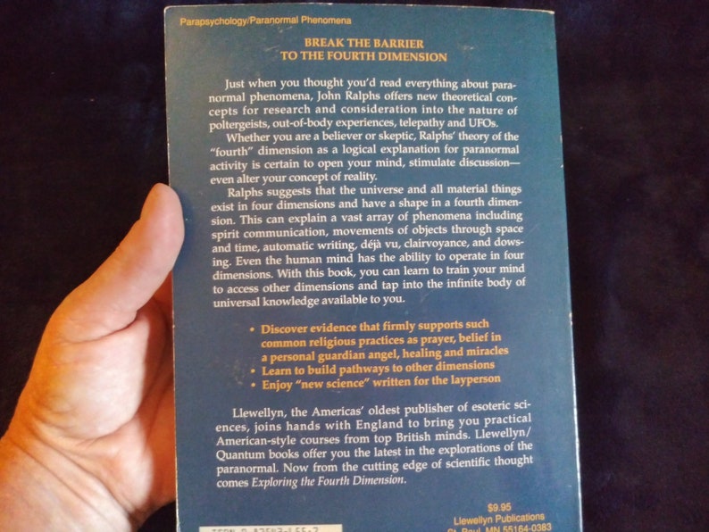 May include: Book cover with a blue background and white text. The title is "Break the Barrier to the Fourth Dimension". The book explores paranormal phenomena and the concept of a fourth dimension.